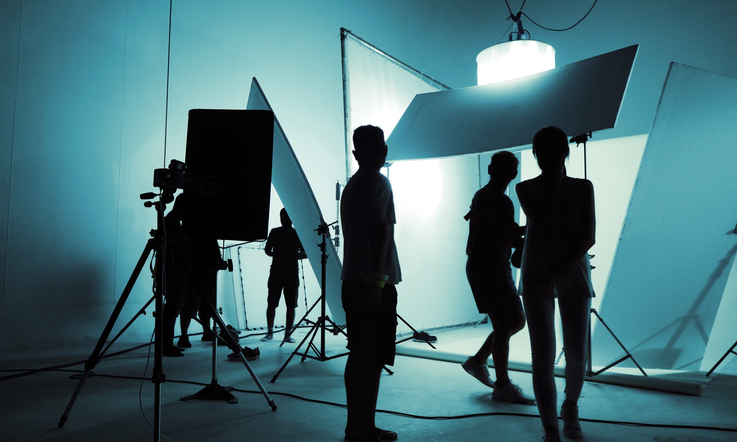 Silhouette_Of_Video_Production_Crew_Team_Working_In_Film_Shooting_Studio_Setup_original_2345869-min